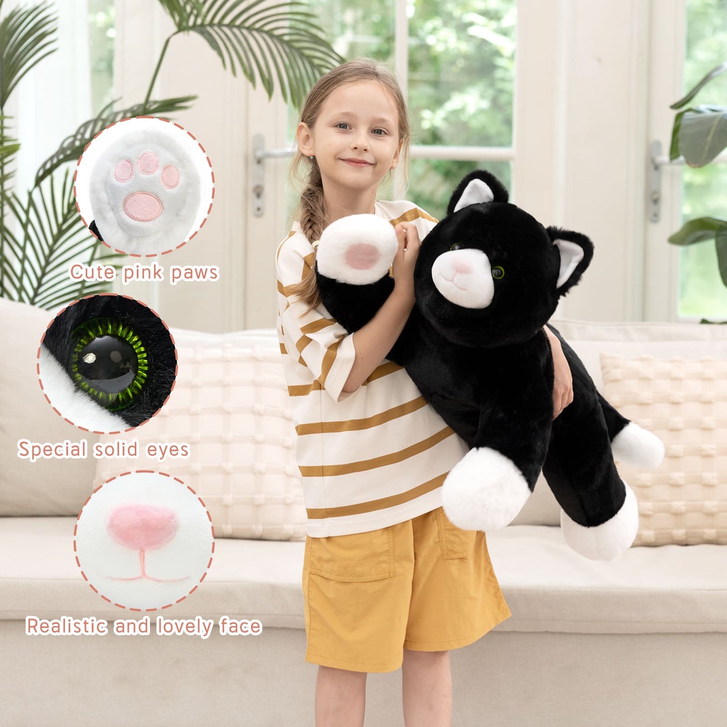 Soft 31-inch black cat plush toy with white paws and pink nose, lying down in a relaxed position, weighted stuffed animal for cuddling and comfort.